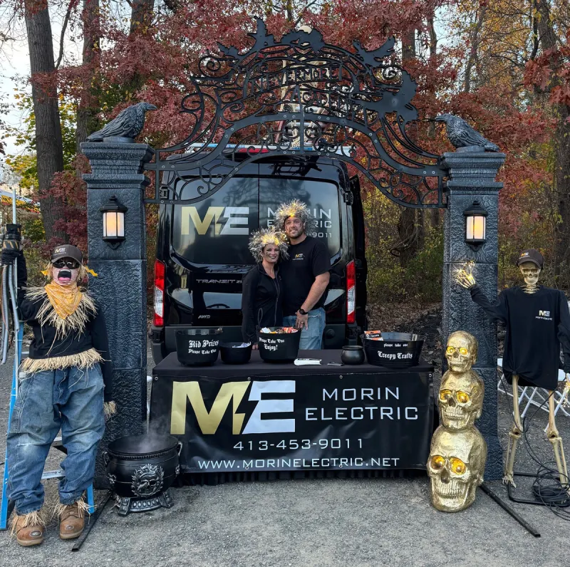 Brent and Kelly Morin with the Morin Electric van at a community event